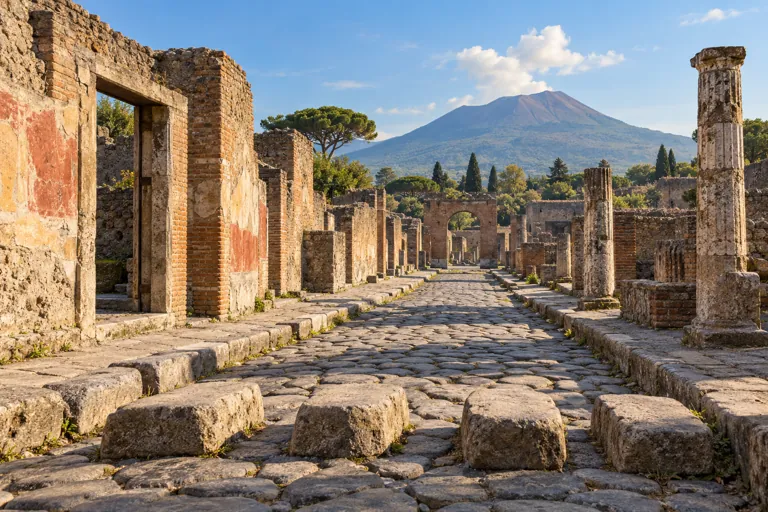 Illustration of a Pompeian stone street, ancient walls and distant Vesuvius