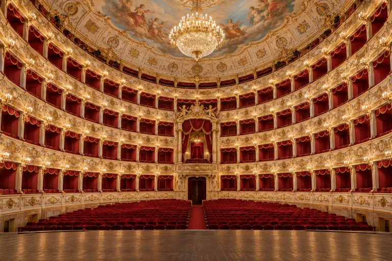 Illustration of an ornate theatre auditorium with red velvet seats and golden boxes